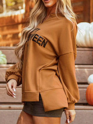 Stylish woman in a brown long sleeve Halloween graphic top with a relaxed fit, perfect for fall celebrations.