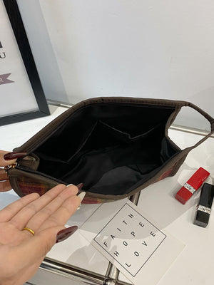 Interior view of the Contrast Plaid Clutch with Zipper, showcasing its spacious black lining and organizational compartments.