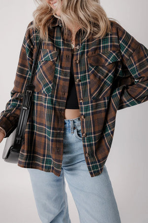 Stylish woman wearing a plaid button-up long sleeve jacket with pockets, paired with jeans and a cropped top.