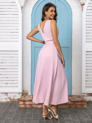 Model wearing a pink full size slit V-neck sleeveless midi dress, showcasing an elegant back view.