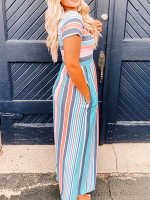 Full size striped round neck short sleeve dress showcased on a model, featuring a relaxed fit and pockets.