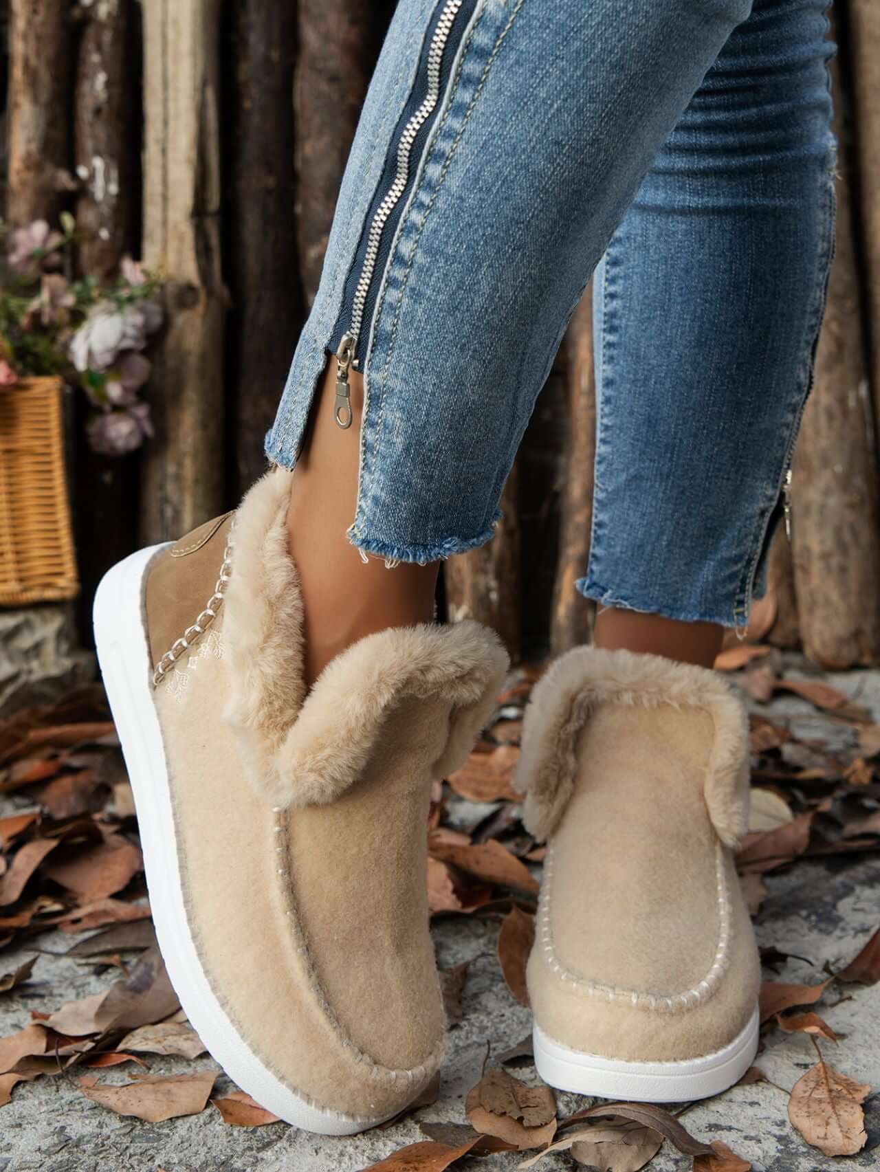 Furry suede round toe flat sneakers in beige, featuring plush fur lining, paired with distressed jeans on a fall backdrop.