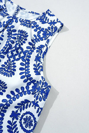 Printed crew neck sleeveless top featuring a blue floral design on a white background, perfect for casual summer wear.