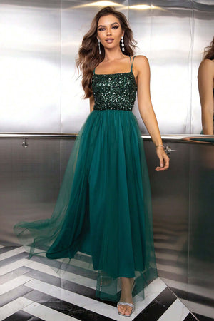 Elegant green maxi dress with sequined bodice, featuring a flowy skirt and spaghetti straps, perfect for special occasions.