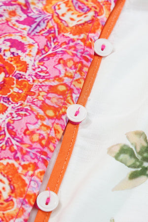 Close-up of buttoned sheer fabric showcasing vibrant floral patterns in orange and pink, ideal for a stylish blouse.