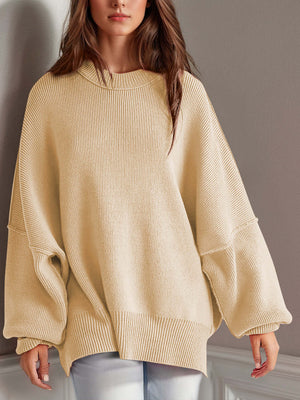 Cozy beige side-slit sweater with a round neck and oversized sleeves, perfect for winter wear.