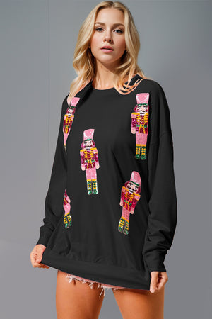 Model wearing Double Take Sequin Nutcracker Round Neck Long Sleeve Sweatshirt with colorful nutcracker design.