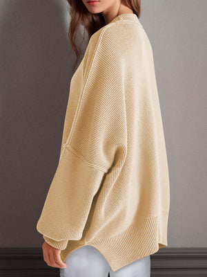 Cozy side-slit sweater in beige with round neck and moderate stretch, perfect for winter fashion.
