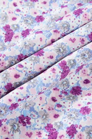 Close-up of floral fabric in pink and blue hues for a tiered floral dress.