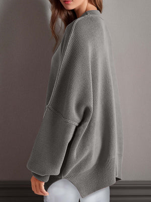 Chic side-slit sweater in gray, featuring a cozy round neck and relaxed fit, perfect for winter styling.
