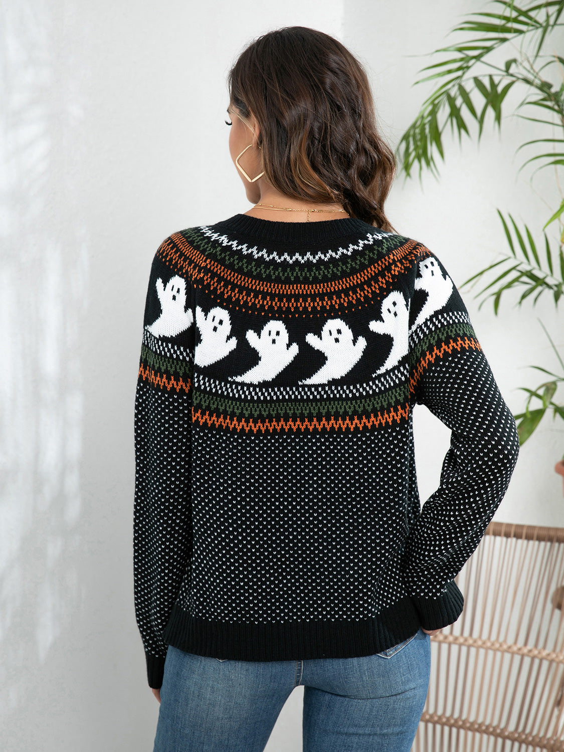 Black cardigan with ghost design on the back, featuring a festive pattern, perfect for Halloween celebrations.