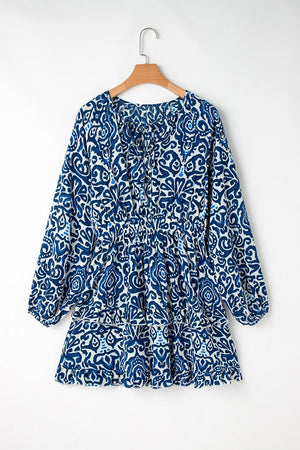 Printed tie neck long sleeve dress in blue floral pattern, perfect for casual or semi-formal occasions.