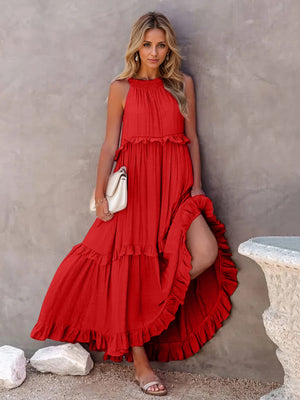Model wearing a ruffled sleeveless tiered maxi dress in red with pockets, styled with a handbag and sandals.