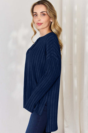 Model wearing Basic Bae ribbed high-low long sleeve T-shirt in navy, showcasing button details and slit sides.