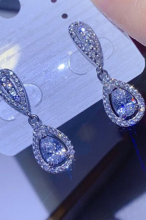 2 carat moissanite teardrop earrings in platinum-plated 925 sterling silver on display, sparkling and elegant.