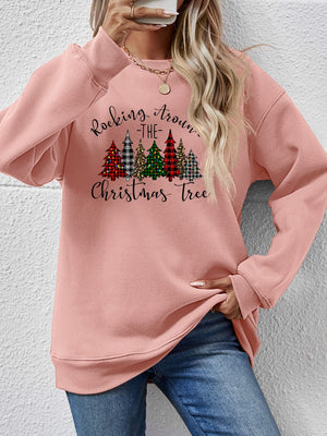 Pink sweatshirt with 'Rocking Around the Christmas Tree' design and colorful trees, perfect for holiday celebrations.