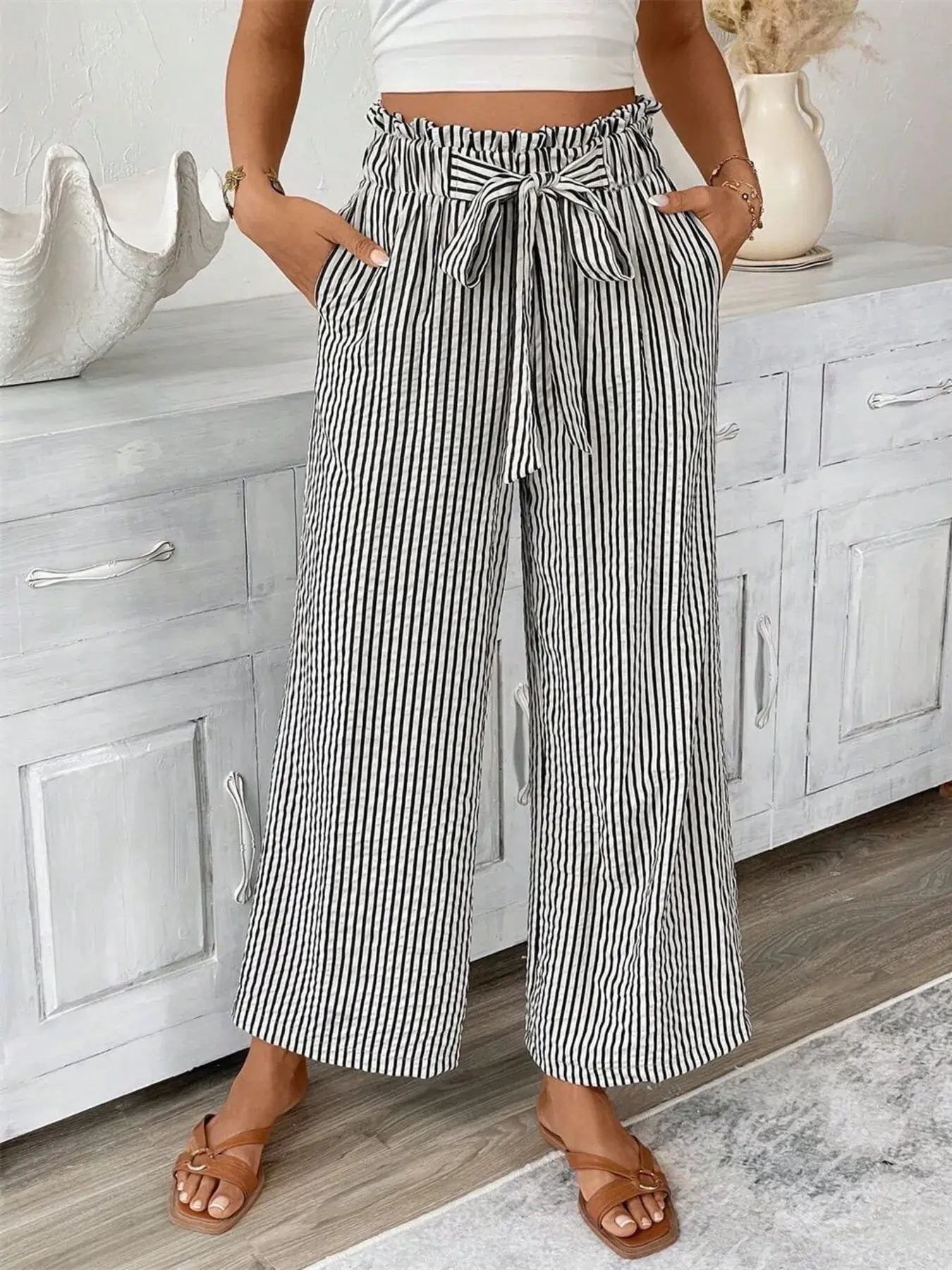 Plus size striped wide leg paper bag pants with pockets, featuring a tied waistband, perfect for stylish comfort.