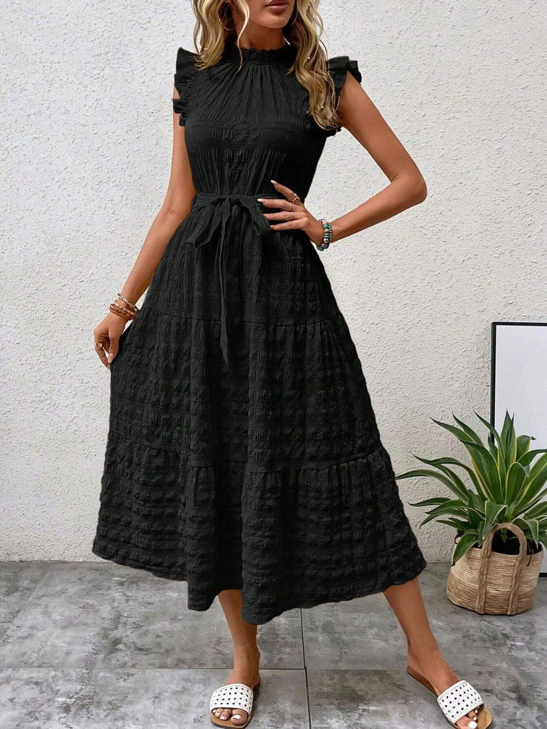 Elegant black midi dress with tied, ruffled cap sleeves and tiered design, perfect for stylish summer outings.