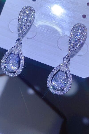 2 carat moissanite teardrop earrings in 925 sterling silver, shimmering with sparkling detail, presented on a display card.