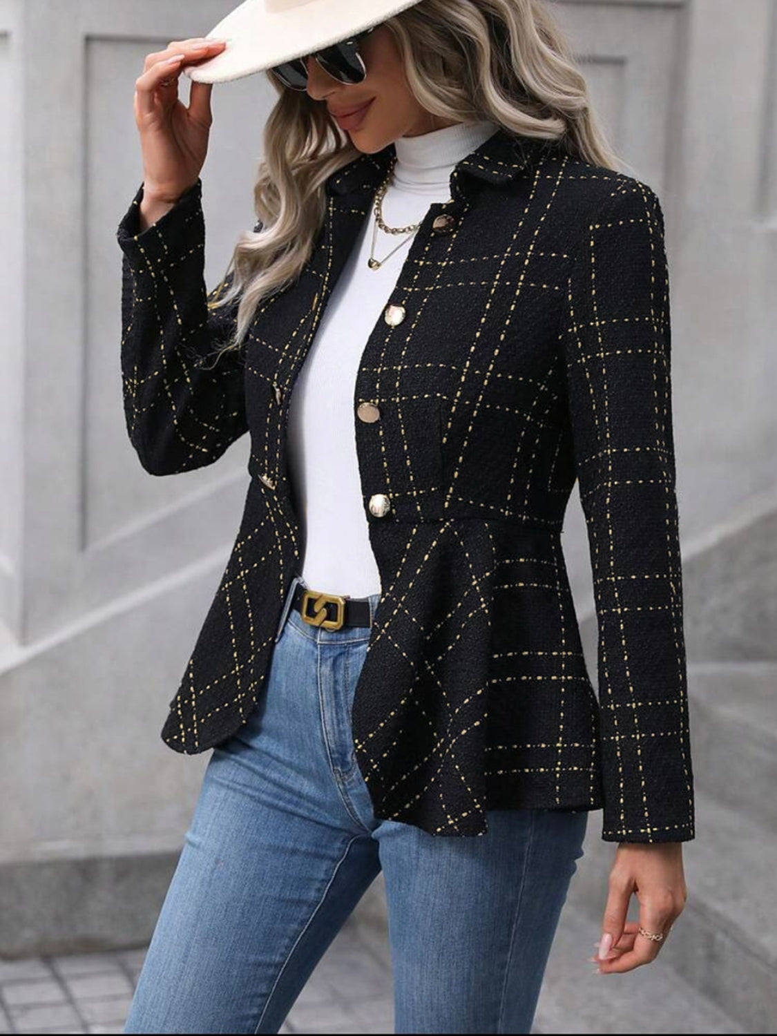 Ruffle hem collared blazer in black with gold plaid, paired with a white turtleneck and blue jeans, stylish outdoor look.