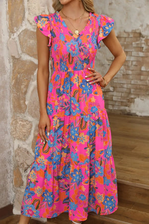 Boho floral v neck ruffle tiered dress in vibrant pink with blue flowers, perfect for summer occasions.