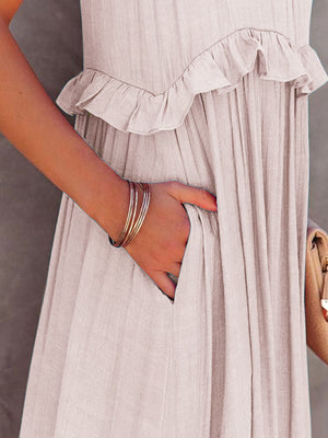 Close-up of ruffled sleeveless tiered maxi dress highlighting pockets and textured fabric.