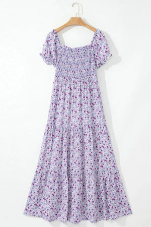 Tiered floral shirred high waist maxi dress on hanger, featuring short sleeves and a lightweight design.