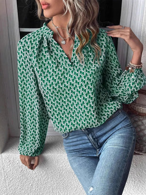 Stylish green printed notched long sleeve blouse, worn with blue jeans, perfect for casual wear.