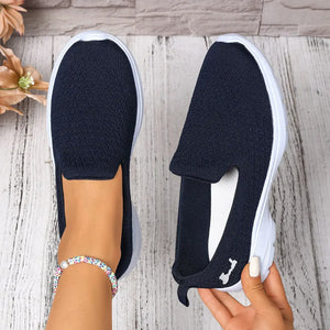 Lightweight breathable mesh slip-ons in navy blue, featuring a low heel and comfortable slip-on design.