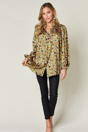 Model wearing Double Take full size printed long sleeve blouse, featuring a vibrant floral pattern and relaxed fit.
