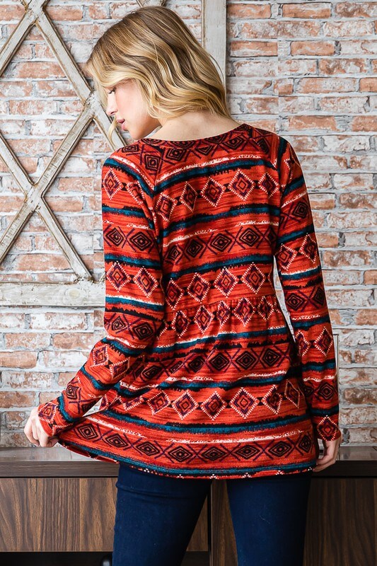 Model wearing a long sleeve geometric patterned babydoll top in red, showcasing stylish details from the back.