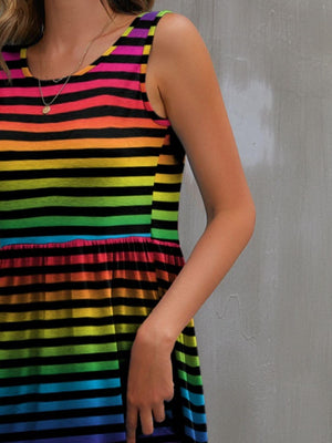 Model showcasing a FAM-FAM round neck wide strap mini dress with vibrant rainbow stripes.