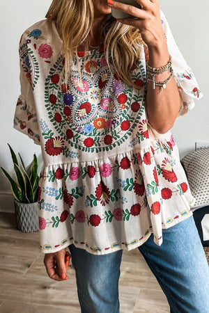 Floral print round neck blouse with ruffle trim, featuring colorful embroidery and a loose fit, perfect for casual wear.