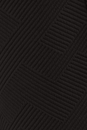 Close-up of textured black fabric featuring a stylish geometric pattern.