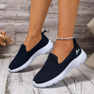 Lightweight breathable navy mesh slip-on shoes featuring low heel and cushioned sole for comfort.