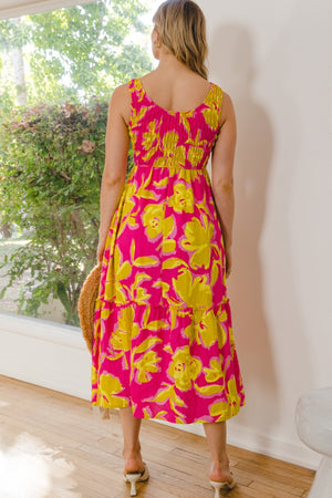 Rear view of ODDI floral smocked ruffled midi dress in vibrant pink and yellow, showcasing elegance and charm.