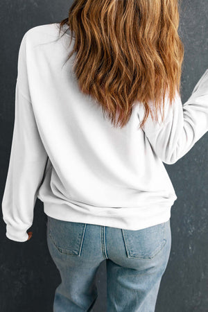 Back view of a woman wearing a FPB round neck long sleeve sweatshirt with casual jeans.