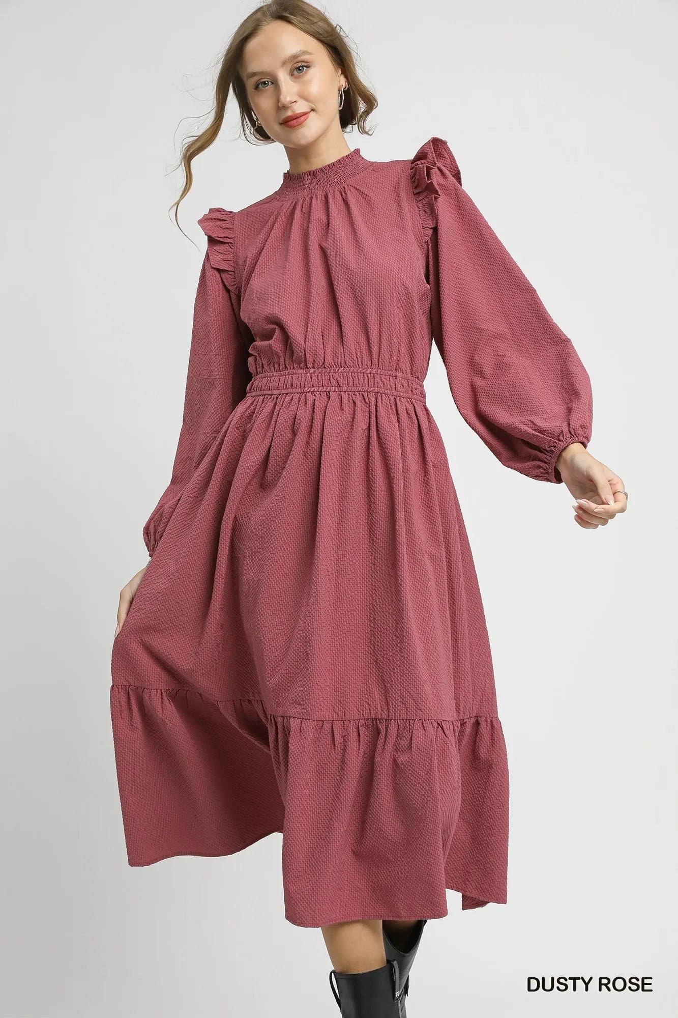 Dusty rose textured midi dress with ruffle shoulder detail, featuring an elegant design and chic feminine vibe.