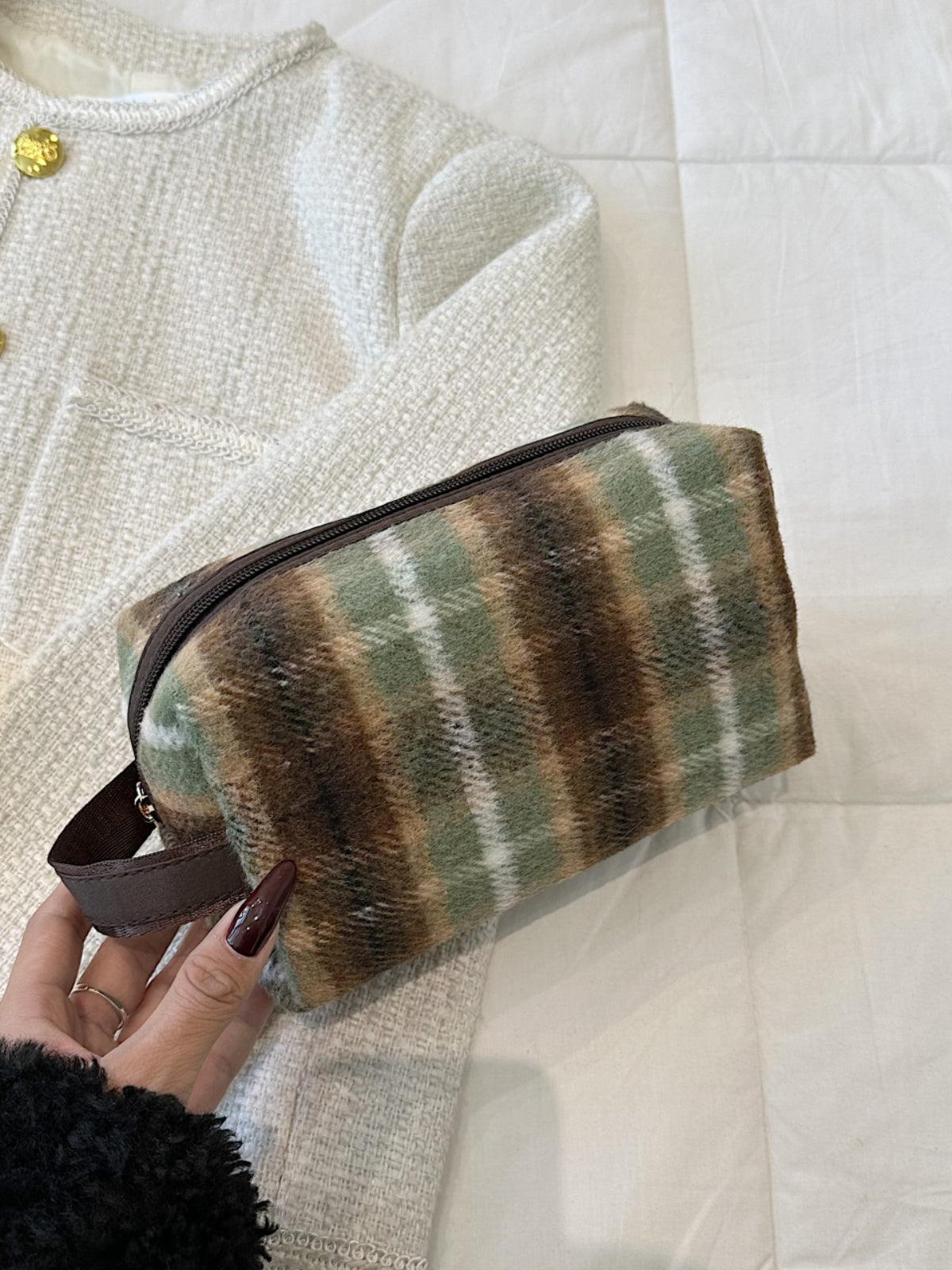 Contrast plaid clutch with zipper in green and brown, small polyester bag for stylish storage on a white background.