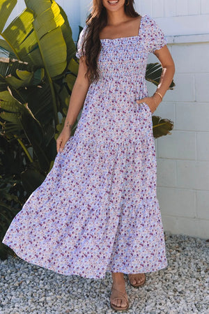 Tiered floral shirred high waist maxi dress, featuring puff sleeves and pockets, perfect for casual outings.