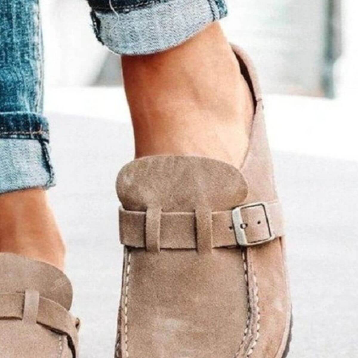 Brown round toe low heel buckle loafers worn with cuffed jeans, showcasing casual and stylish footwear.