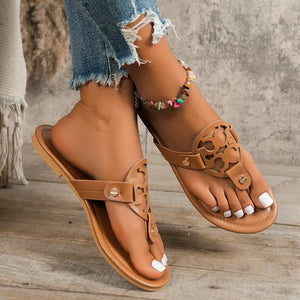 Stylish toe post flats sandals in tan color, perfect for casual summer outfits, featuring a decorative design.