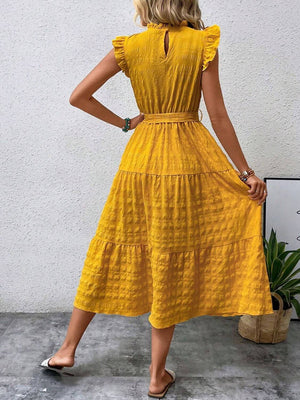 Back view of a woman wearing a tied ruffled cap sleeve midi dress in vibrant yellow, showcasing its flowy silhouette.