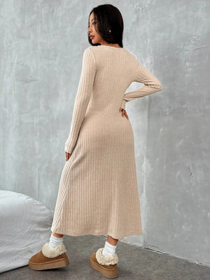 Back view of a woman in a ribbed long sleeve knit dress, showcasing its slightly stretchy fabric and comfortable fit.