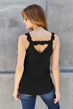 Back view of a woman wearing a black lace detail v-neck cami top with a stylish cutout.