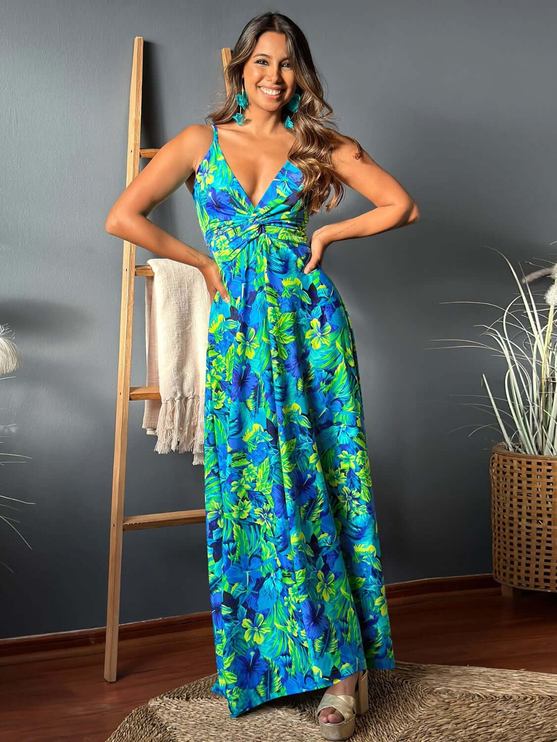 Model wearing a vibrant blue and green floral Twisted Printed V-Neck Cami Dress, showcasing its stylish design and vibrant colors.