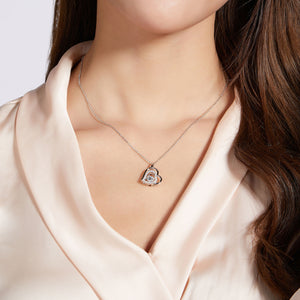 Elegant Moissanite 925 sterling silver heart necklace showcased on a model wearing a silk blouse.