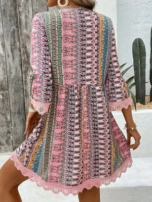 Back view of lace trim printed V-neck dress with 3/4 sleeves in a colorful pattern, perfect for summer outings.