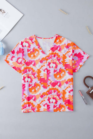 Colorful printed v-neck short sleeve blouse in vibrant pink and orange floral pattern, made of 100% polyester.