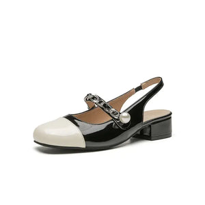Contrast round toe block heel Mary Jane shoes with decorative chain and pearl detail in black and white.